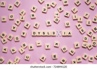 dyslexia concept - alphabet letters on pink background
