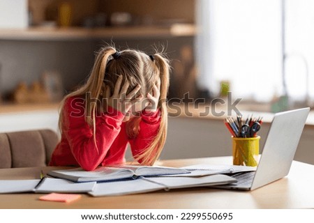 Dyslexia Concept. Little Girl Struggling With Homework, Stressed Preteen Female Child Having Reading Difficulties, Sitting At Desk At Home, Looking At Book And Touching Head With Despair, Copy Space