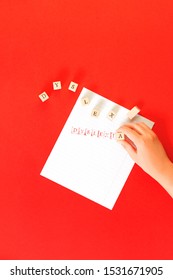 Dyslexia Word Stamped By Kids Hand On Ruled Paper With Red Ink On Red Background, Reading Difficulty Awareness And Disorder Cliche Concept. Education And Neurology With Copy Space