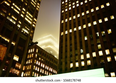 Dystopian Toronto skyscrapers in the fog on a rainy day, glowing and making a blade runner like slum look. Shining in the mist. - Powered by Shutterstock - Get 15% off with code: PIKWIZARD15