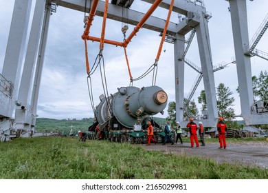 Dzerzhinsk, Russia, June 3, 2022. Loading of a chemical reactor in a port terminal using a gantry crane on a three-axis conveyor