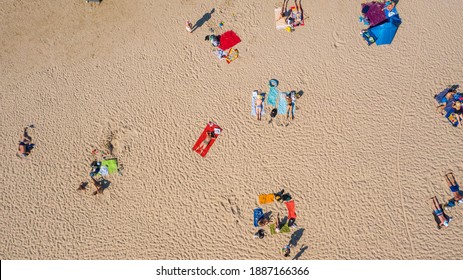 Dzintari,Jurmala,Latvia,Baltics. Aerial view photo from flying drone panoramic to Dzintari sandy beach full of people sunbathing and swimming in the Baltic Sea on a hot and sunny summer day. (Series)