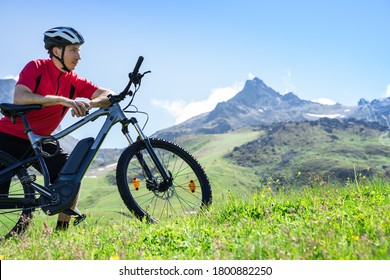 E Bike Bicycle In Austria. Man In Helmet With Mountain Ebike