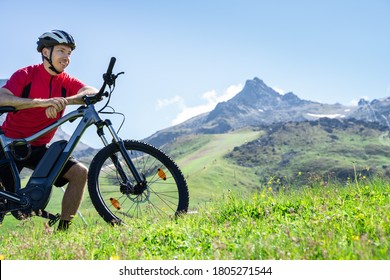 E Bike Bicycle In Austria. Man In Helmet With Mountain Ebike