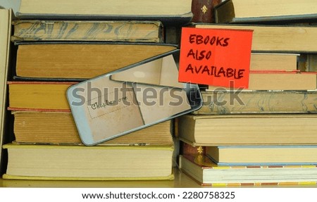 e book concept with stack of books,e book reader and sign with  message e books also available