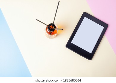 E book reader and aroma diffuser on geometric backgrond for calm reading and relaxing
