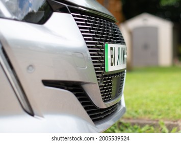 E Electric e-car front grill  showing close up of green stripe indicating electric on number plate