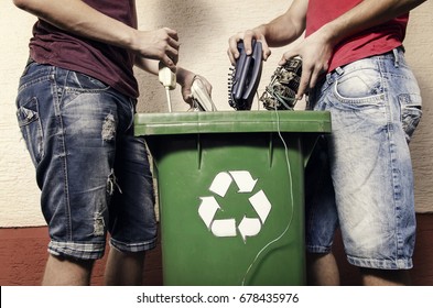 E waste concept, two man putting electronic waste into recycle bin 