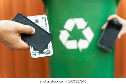 E Waste , Recycle Concept , Disassembled Smartphone And Recycle Bin In Background 