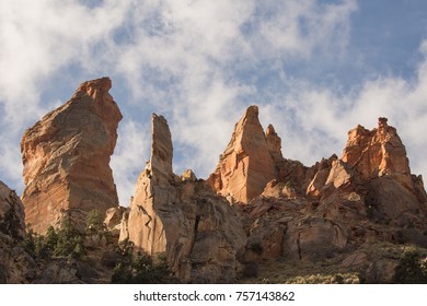 Eagle's Crag Summit With The Rock Formation Known As Mrs. Butterworth By Rock Climbers In Morning Light With Puffy Clouds Drifting By.