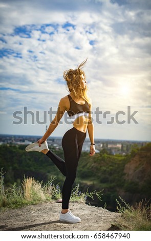 ealthy sports lifestyle. Athletic young woman in sports dress doing fitness exercise. Fitness woman on stadium.
