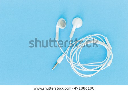 ear buds or earphones on green background