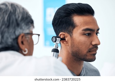 Ear check, man and ENT doctor with patient consultation for hearing and wellness at hospital. Senior, employee and otoscope test of physician with healthcare work and consulting exam with expert - Powered by Shutterstock