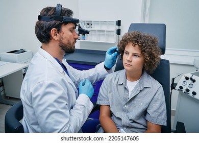 Ear Check-up In Child, Otolaryngology. Curly Boy Patient During Ear Exam With Doctor In ENT Office At Medical Clinic