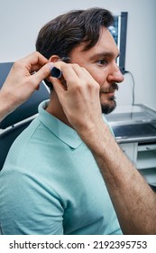 Ear Check-up, Otolaryngology. Man Patient During Ear Exam With Doctor In ENT Office At Medical Clinic