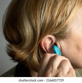 Ear Cleaning. Woman Removing Wax From An Ear With A Wax Remover.