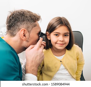 Ear Exam. Pediatrician Examining Little Mixed Race Child With Otoscope, Hearing Exam Of Child