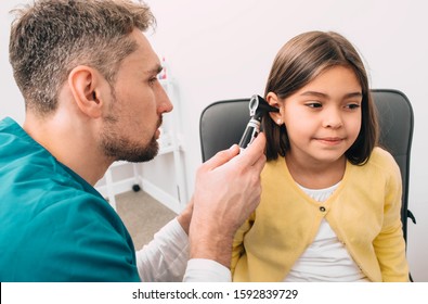 Ear Exam. Pediatrician Examining Little Mixed Race Child With Otoscope, Hearing Exam Of Child