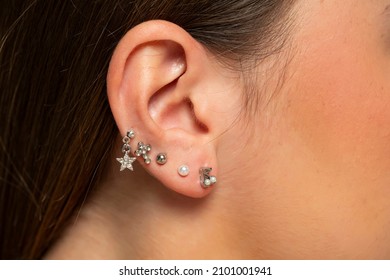 ear piercings photos.Helix piercing.Ear rings. Close up.