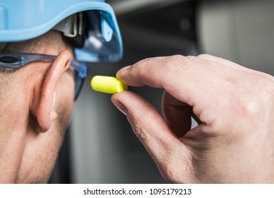 Ear Plugs Hearing Protection Simple Solutions. Factory Worker in Blue Hard Hat Preparing To Use Foamy Plug. - Shutterstock ID 1095179213