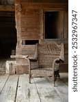 EARLY 20TH CENTURY WICKER CHAIR IN MID-19TH CENTURY BARN