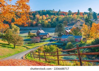 An early autumn foliage scene of houses in Woodstock, Vermont mountains