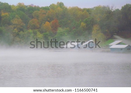 Early autumn morning foggy view across Falls Creek Falls Lake looking at Village Camp Road boat marina in Falls Creek Falls State Park, Tennessee.