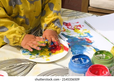 Early Childhood Development Activity: Finger Painting Outside On A Sunny Day