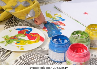 Early Childhood Development Activity: Finger Painting Outside On A Sunny Day