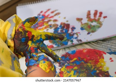 Early Childhood Development Activity: Finger Painting Outside On A Sunny Day