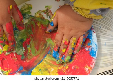 Early Childhood Development Activity: Finger Painting Outside On A Sunny Day