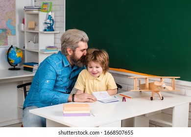 Early Development. School Community Partnership. Kid And Teacher Is Learning In Class On Background Of Blackboard. Homework Help. Preschool Education