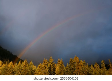 An early fall sunset with double rainbow
