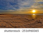 Early morning along the Gulf of Mexico.  The beach moves on the miles and miles.  Calm waters, and slow breezes make for a perfect start to the day.