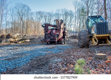 Early Morning At The Construction Site Where Tractors Are Clearing A Wooded Lot For A Building Site