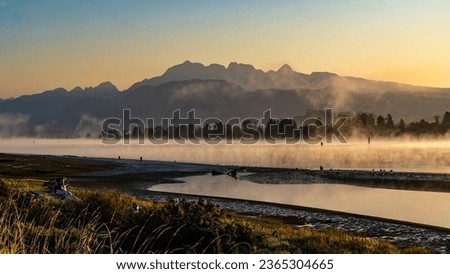 Early morning fog covering Pitt River and Golden Ears Mountain. View from Port Coquitlam Trail, BC, Canada. Stockfoto © 
