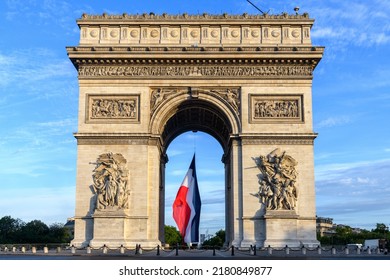 Early in the morning, the French flag is installed on the Arc de Triomphe for the Bastille Day parade.