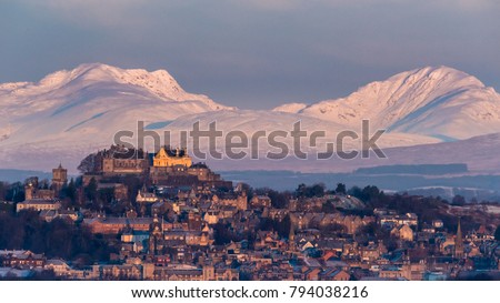 The early morning light on Stirling castle and wintery hills beyond
