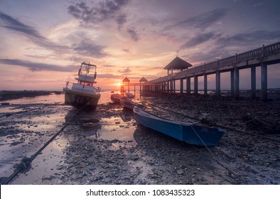 Early morning scenery of stranded boats by beach during low tide at fishermen`s jetty - Powered by Shutterstock