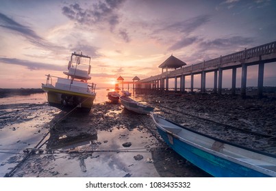 Early morning scenery of stranded boats by beach during low tide at fishermen`s jetty - Powered by Shutterstock