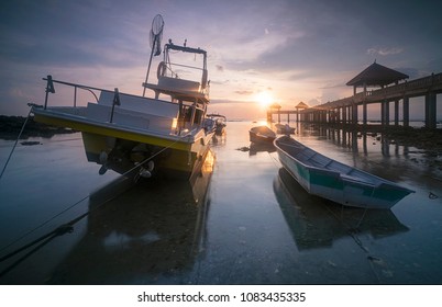 Early morning scenery of stranded boats by beach during low tide at fishermen`s jetty - Powered by Shutterstock