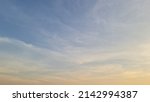 The early morning sky in the dry season was streaked with white and orange streaks of clouds floating in the bright blue sky. 