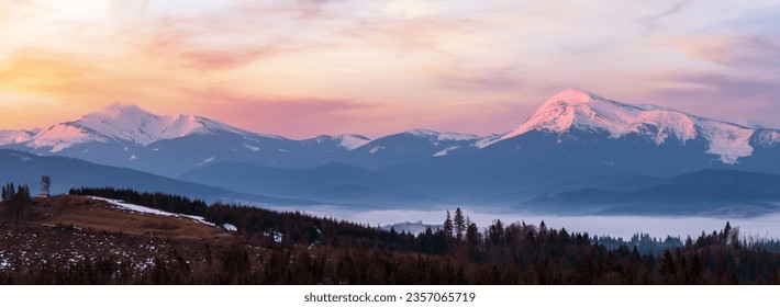 Early morning spring Carpathian mountains plateau landscape with snow-covered ridge tops in far, Ukraine. - Powered by Shutterstock