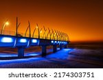 An early morning summer sunrise over the unique whalebone pier, located in Durban, South Africa, which is a popular tourist attraction.