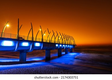 An early morning summer sunrise over the unique whalebone pier, located in Durban, South Africa, which is a popular tourist attraction. - Shutterstock ID 2174303751