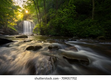 Early morning sun rays over waterfall in Pisgah National Forest