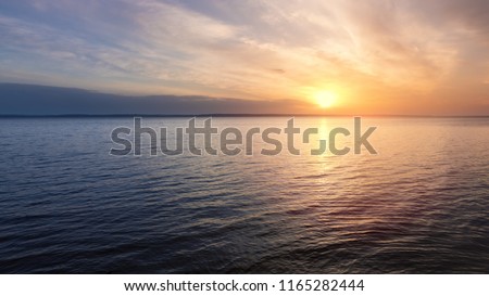 early morning sunrise on a choppy river / wind early spring landscape