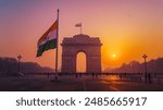 Early morning sunrise on india gate New Delhi with Indian flag waving in air	