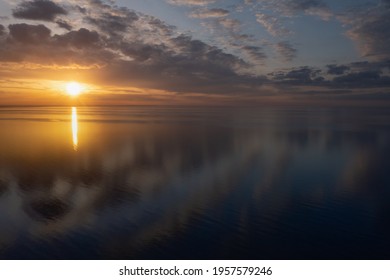 Early morning sunrise over the sea . Some clouds. - Shutterstock ID 1957579246