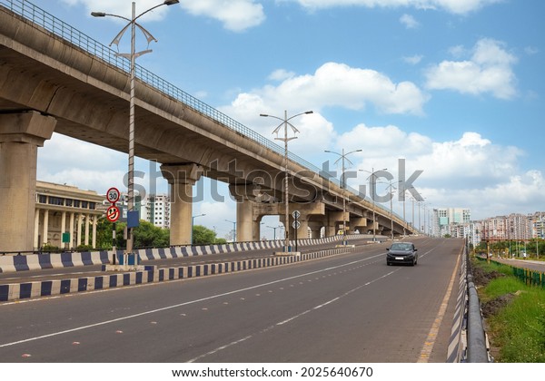 Early\
morning traffic on city road with view of flyover and commercial\
and residential buildings at Rajarhat area\
Kolkata